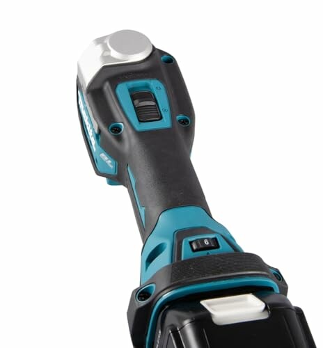 Handle of a cordless angle grinder with adjustment dial.