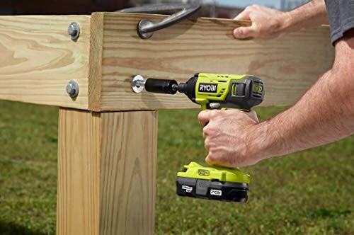 Person using a cordless drill to tighten a bolt on a wooden structure.