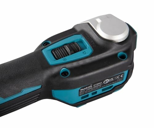 Close-up of a cordless power tool handle with controls.