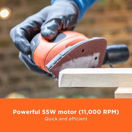 Person using an electric sander on wood.