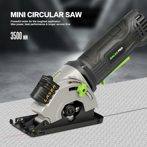 Mini circular saw with laser guide on textured surface.