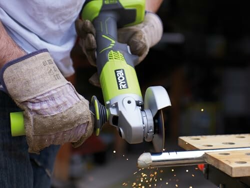 Person using an angle grinder on metal with sparks flying.