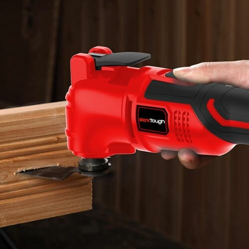 Red power tool cutting wood with precision blade.